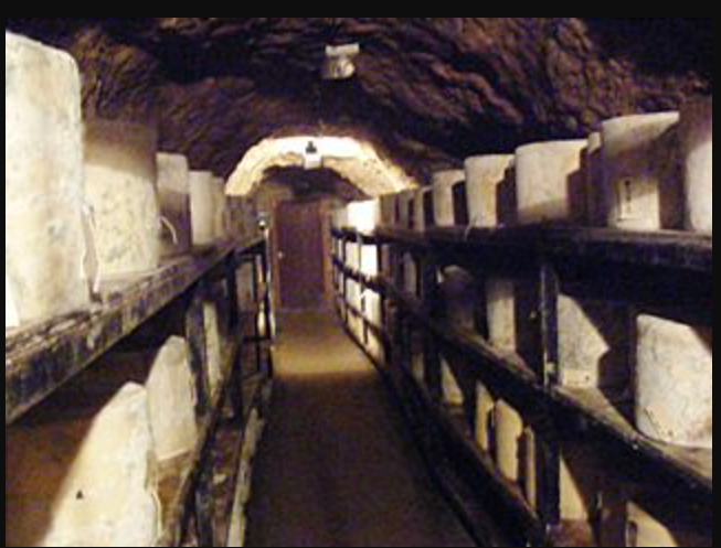 Cheeses being stored and matured at Wookey Hole Caves